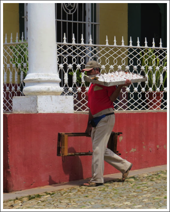 TRINIDAD–Deliveryman with goodies passing one of the lovely old mansions of the sugar barons