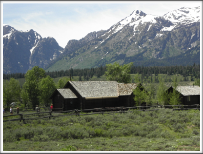 GRAND TETONS: settler’s cabin and barn in a valley