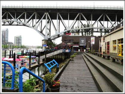 VANCOUVER–a boardwalk on Granville Island leads to...