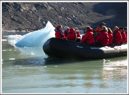 EVIGHEDSFJORD—bundled up in a zodiac, we get up close and personal to the edge of the glacier